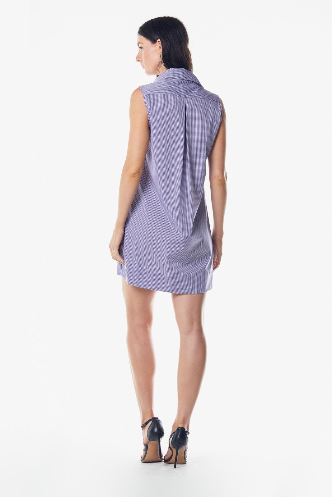 Woman wearing a sleeveless purple dress on a white background