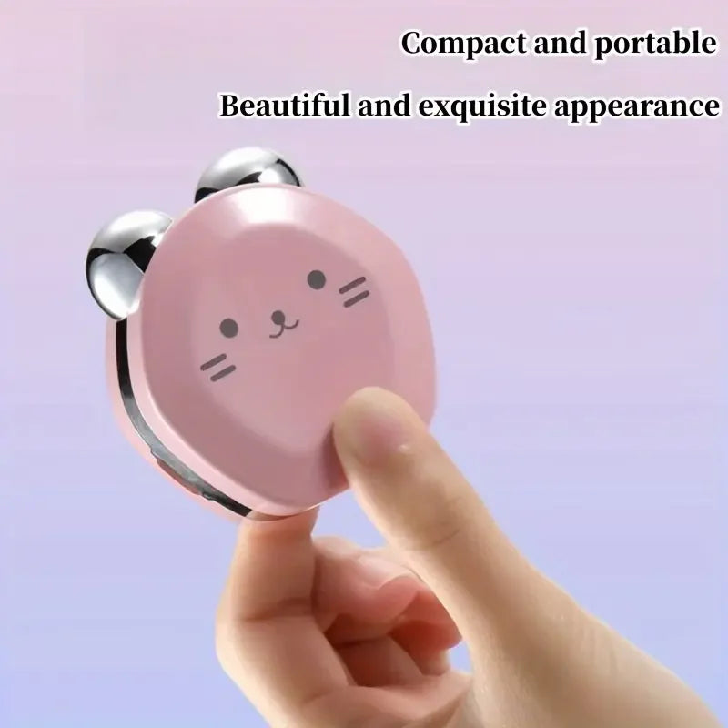 Compact pink mirror with cat face design held by a hand against a light purple background