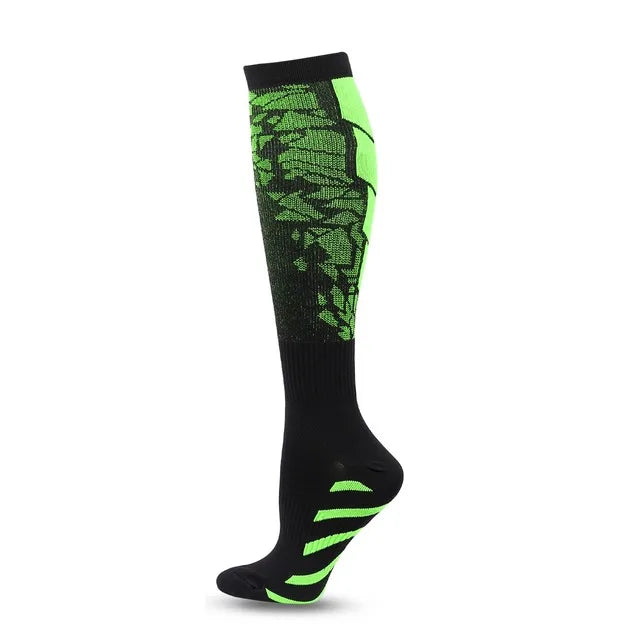 The Littles Collection Compression Socks Varicose Veins Medical Marathon are knee-high black socks with bright green geometric patterns and foot accents, shown on a mannequin leg against a white background. Ideal for stylish support and athletic use.