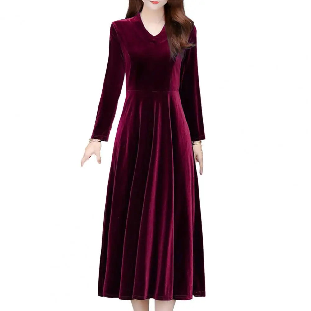 Maroon velvet dress worn by a model on a white background