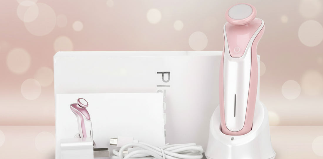 Pink and white electronic device with charging cable on a light pink background