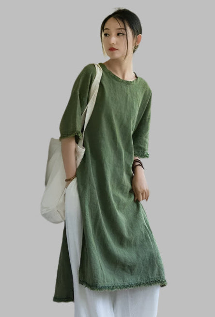 Woman in a green dress standing in an abandoned building