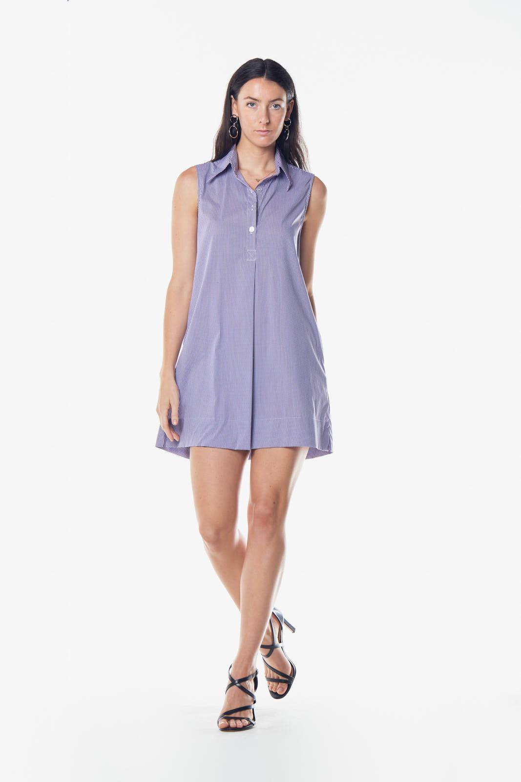 Woman wearing a sleeveless purple dress on a white background