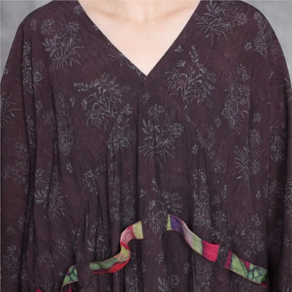 Dark purple dress with floral pattern and colorful trim on a neutral background