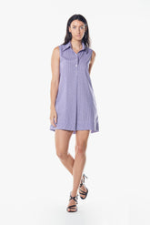 Woman wearing a sleeveless purple dress on a white background