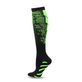 The Littles Collection Compression Socks Varicose Veins Medical Marathon are knee-high black socks with bright green geometric patterns and foot accents, shown on a mannequin leg against a white background. Ideal for stylish support and athletic use.
