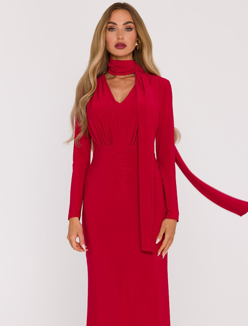 Woman wearing a red dress with a matching cardigan on a white background