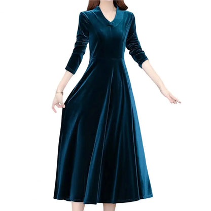 Teal velvet dress worn by a model on a white background
