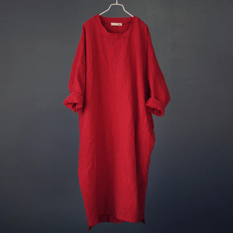 Red dress on a hanger against a dark gray background