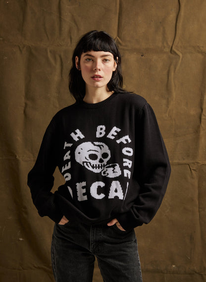 Person wearing a black sweatshirt with a graphic design against a brown background